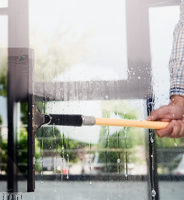 commercial-window-cleaner A commercial window cleaner cleaning interior office windows.