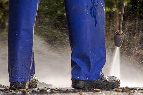 pressure-washing Pressure washing the front sidewalk of a business.